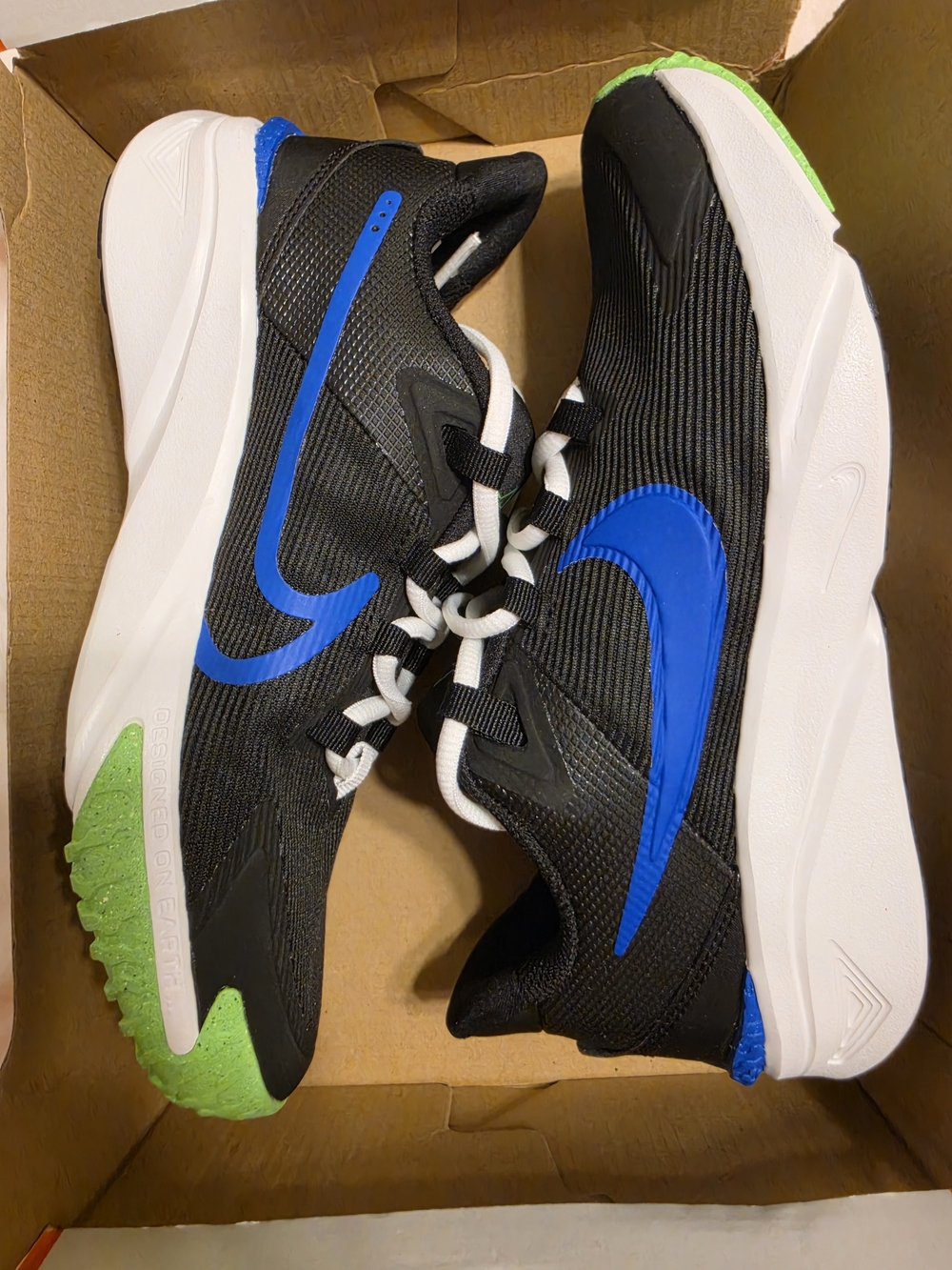 Nike Kids' Black Athletic Sneakers with Blue Swoosh and Green Accents